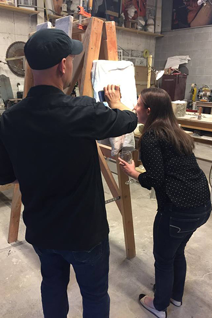 Sebastian Martorana '03 shows a finished piece to Kaitlin Brennan '09