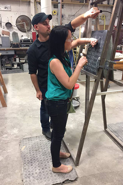 Sebastian Martorana '03 assists Sarah Nelson-Balonis '05 with carving