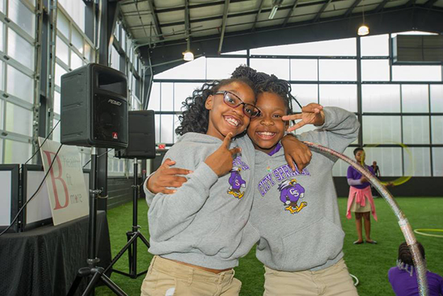 Students pause from hula hooping to smile for the camera