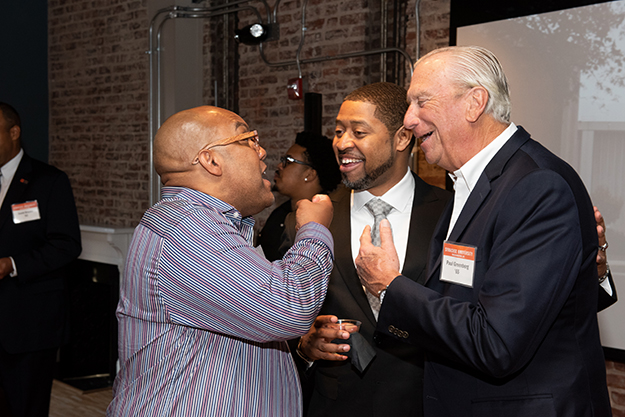 Paul Greenberg '65 jokes with Coach Quentin Hillsman